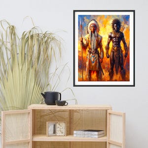 Framed colorful art print hanging on a white wall above a wooden cabinet with a teapot, dried plant, and small framed picture.