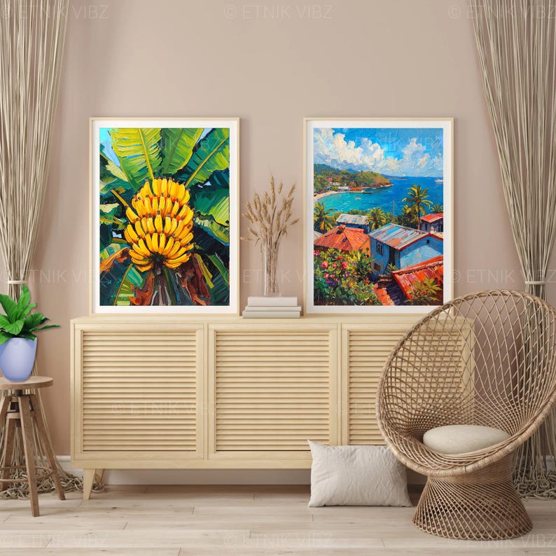 May include: Two framed art prints. One shows a bunch of yellow bananas with green leaves. The other depicts a coastal scene with blue water, red-roofed buildings, and palm trees. The artwork is displayed on a light wood cabinet.