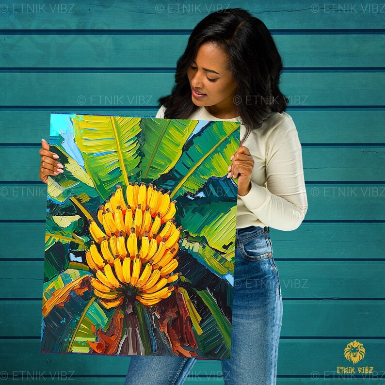 May include: A square canvas print depicting a bunch of yellow bananas and green leaves. The artwork uses bold brushstrokes and a vibrant colour palette, with a tropical theme. The print is held by a person.