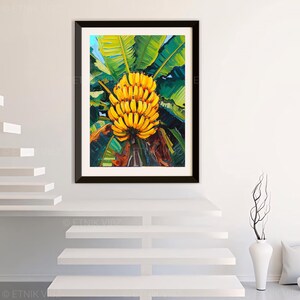 May include: A framed art print depicting a bunch of ripe yellow bananas. The bananas are surrounded by large green leaves, with a blue sky visible. The artwork is presented in a black frame, suitable for home decor.