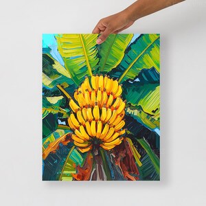 May include: A colourful painting depicting a cluster of yellow bananas, contrasted by vivid green banana leaves. The artwork uses bold brushstrokes and has a tropical theme, with glimpses of blue sky visible.