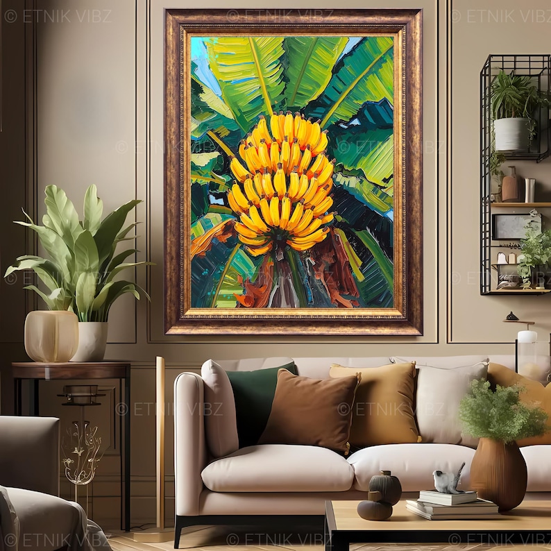 May include: A framed painting depicting a cluster of yellow bananas set against lush green foliage. The artwork is encased in a gold-toned frame and displayed on a neutral wall. The painting is a central feature in a living room setting.