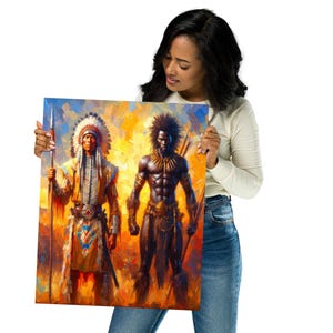 A smiling woman wearing a white long-sleeve shirt and jeans holds up a colorful art print of a Native American warrior and an African warrior.