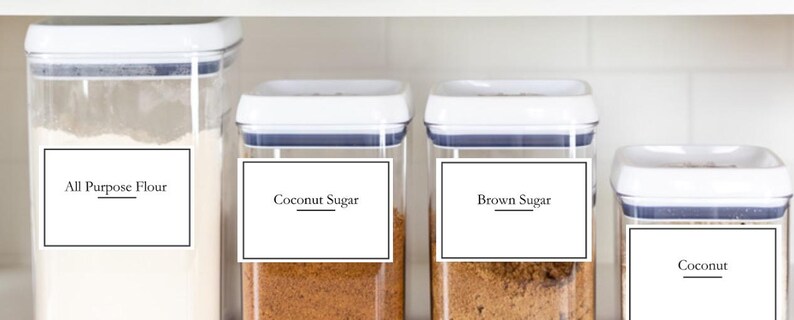 May include: Four white plastic containers with labels on the front. The labels are black with white text. The containers are filled with different ingredients, including flour, coconut sugar, brown sugar, and coconut.