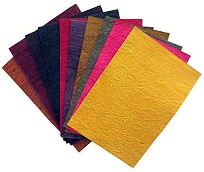 May include: A selection of textured paper sheets in a range of colours, such as gold, pink, purple, and brown. The paper has a crinkled texture, possibly indicating a handmade or artisanal finish. Suitable for crafts, scrapbooking, or creative uses.