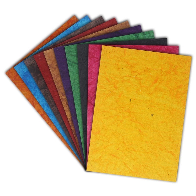 May include: A selection of textured paper sheets in a range of colours, including orange, blue, brown, red, purple, green, pink, and yellow. The paper has a handmade look, with visible fibres and a slightly uneven surface.