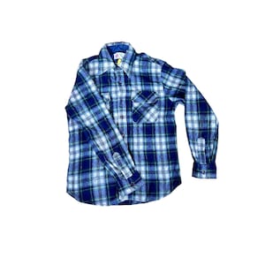 May include: A blue, green, and white plaid flannel shirt with long sleeves. The shirt has a button-down front, a chest pocket, and buttoned cuffs. The collar is a dark blue color.