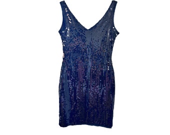 May include: A sleeveless sequined dress in a dark blue colour. The dress has a V-neckline and a fitted silhouette.