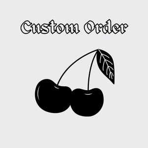 May include: Black and white illustration of two cherries with a stem and leaf. The text "Custom Order" is above the cherries.