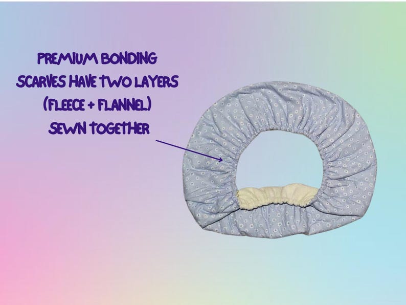 May include: A light blue, floral-patterned scarf with a fleece and flannel interior. The text reads "Premium Bonding Scarves Have Two Layers (Fleece + Flannel) Sewn Together."