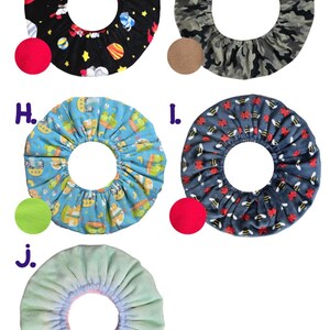 May include: Circular fabric covers in various patterns. Designs include a black space-themed print, camouflage, a blue pattern with cartoon characters, a navy pattern with bees, and a light green cover.