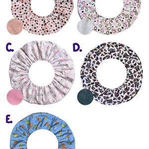May include: Five fabric covers with a central hole, each with a unique pattern. Designs include small flowers, circles, paw prints, leopard print, and dinosaurs. Each cover has a coordinating colour swatch.
