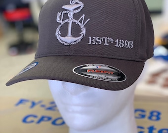 May include: A gray baseball cap with a white embroidered anchor and the text "EST'D 1808". The cap has a black Flexfit label with the text "The Original Flexfit It Fits Your Life L/XL".