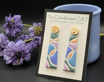 Mod geometric handmade earrings: pastel colors, resin-coated, with light-colored round wood studs