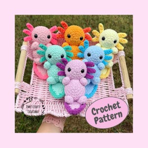 May include: A collection of colorful, crocheted axolotls in a pink woven basket. The axolotls are in various colors, including pink, orange, green, blue, and purple. The image also includes a pink oval with the words "Crochet Pattern".