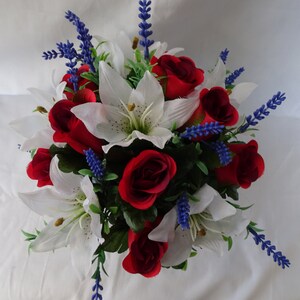 May include: A bouquet of artificial flowers featuring white lilies, red roses, and blue lavender sprigs.