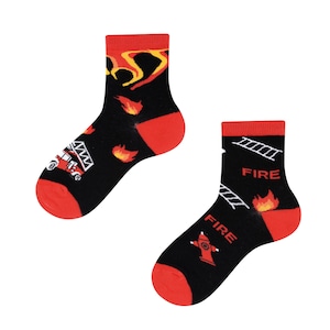 May include: Pair of black socks with red detailing, decorated with fire-related imagery. One sock shows a fire engine and flames, the other has ladders, a fire hydrant, and the word "FIRE".