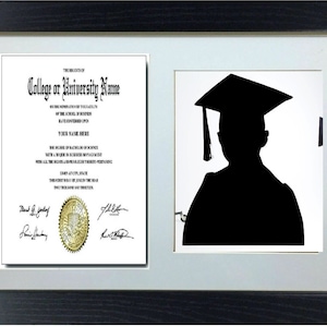 May include: A black and white silhouette of a person wearing a graduation cap and gown. The silhouette is set against a white background. The image is framed in a black frame with a white mount.