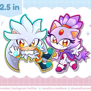 May include: A sticker featuring two cartoon characters, Silver and Blaze, from the Sonic the Hedgehog series. Silver has white fur and Blaze has purple fur. The sticker is 2.5 inches in size.