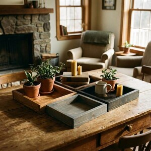 May include: Wooden trays in various shades of brown and gray are arranged on a wooden table. The trays hold potted plants, candles, and a mug. The scene is set in a cozy living room with a fireplace and natural light.