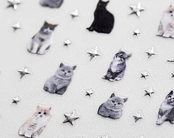 May include: A sheet of clear adhesive stickers featuring various poses of cats with silver star accents. The sheet includes the text "la-233", "新学期准备", and "金"