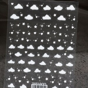 May include: A sheet of clear sticker paper with white cloud, star, and heart stickers. The sheet has the text "TS-536 小云朵" printed on it.