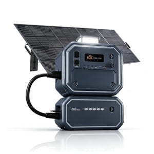 May include: A dark gray portable power station stacked on a matching battery pack, connected by a black cable. A large, rectangular solar panel stands behind the units. The power station features a digital display showing 100 percent, multiple ports, and a power button.