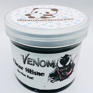 May include: A black slime jar with a white label that says "Venom Clear Slime The Toxic Treat". The label also features a cartoon image of Venom, a Marvel Comics character.