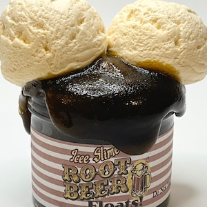 May include: A jar of "Icee Slime Root Beer Floats!" with two scoops of vanilla ice cream on top. The slime is dark brown and oozes over the jar's rim. The jar has a brown and white striped label with text and a beer mug graphic.