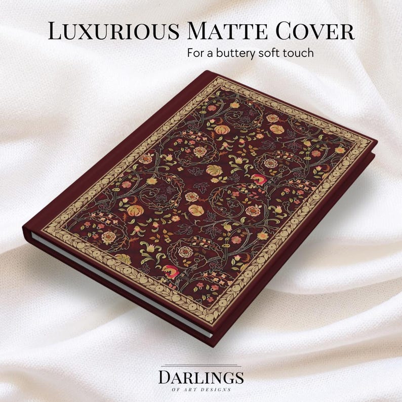 May include: A maroon journal with a floral design on the cover. The cover has a gold border and the text "Luxurious Matte Cover" and "For a buttery soft touch". The journal is from Darlings of Art Designs.