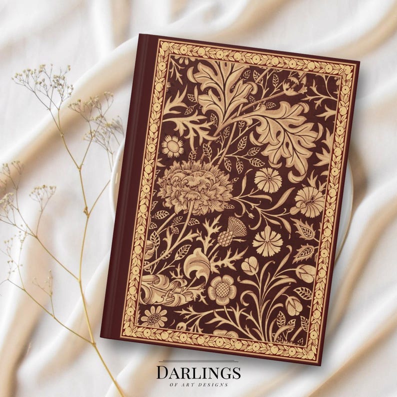 May include: A burgundy journal with a gold floral design and the text "Darlings of Art Designs" on the front cover.