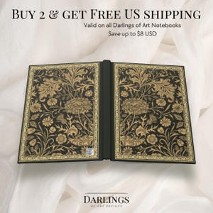 May include: A black notebook with a gold floral design on the cover. The notebook is open to reveal a blank page. The text "BUY 2 & GET FREE US SHIPPING" is at the top of the image. The text "Valid on all Darlings of Art Notebooks" is below the first line of text. The text "Save up to $8 USD" is below the second line of text. The text "DARLINGS OF ART DESIGNS" is at the bottom of the image.