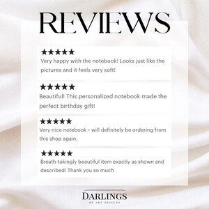 May include: Image featuring the word "REVIEWS" in a bold, elegant font. Below, customer testimonials with five-star ratings praise a notebook, describing it as soft, beautiful, and a perfect gift. The shop's name, "DARLINGS OF ART DESIGNS," is at the bottom.
