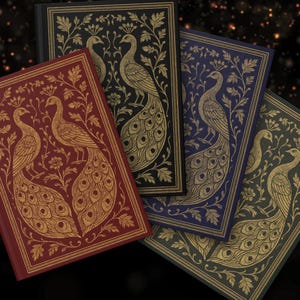 May include: Four rectangular hardback journals featuring gold-coloured line art of peacocks and floral patterns. The covers are in shades of deep red, black, dark blue, and dark green, each displaying a symmetrical design of two birds facing each other.