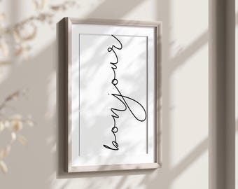 May include: A white framed print with the word "bonjour" written in black cursive script.