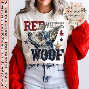 May include: Cream-colored t-shirt featuring a dog illustration with patriotic colors and the words "RED WHITE & WOOF." The design includes stars and the text "original designer." The shirt has short sleeves.