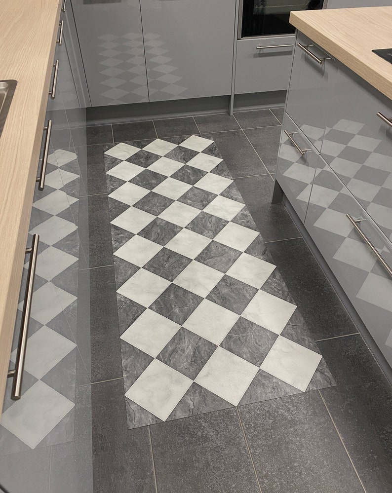 checkerboard runner rug in kitchen with black tiles and grey units