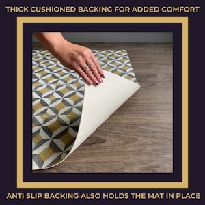 May include: A close-up of a patterned floor mat with a geometric design in shades of yellow, gray, and white. The mat has a thick, cushioned backing and an anti-slip backing to help keep it in place. "THICK CUSHIONED BACKING FOR ADDED COMFORT" and "ANTI SLIP BACKING ALSO HOLDS THE MAT IN PLACE" are printed on the image.