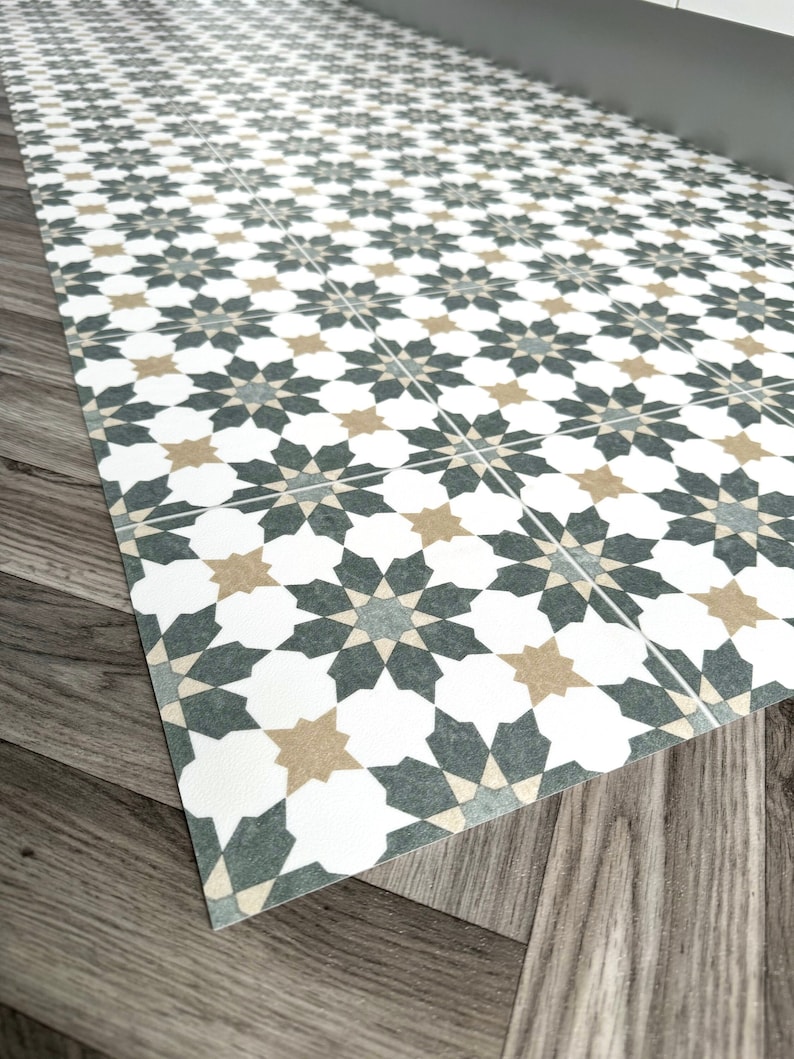 green and white star tile design vinyl mat on grey herringbone floor