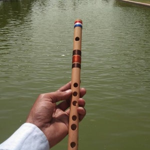 May include: A set of three ceramic mugs with a speckled, matte finish. The mugs are in shades of cream, light brown, and dark brown. Each mug has a simple, minimalist design and a rounded handle.