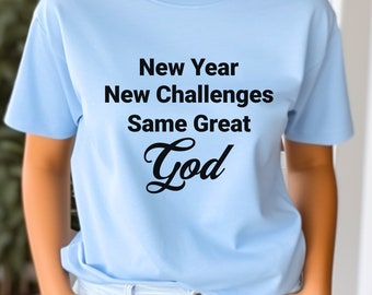 May include: Light blue t-shirt with the text "New Year New Challenges Same Great God" in black lettering.