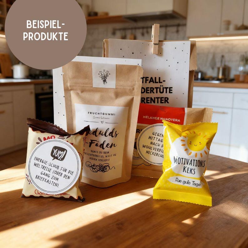 May include: A collection of packaged snacks and treats, including a yellow bag with "MOTIVATIONS KEKS" text and a sun graphic. Other packages are brown with white labels and text, and a small bag with "Yum!" text.