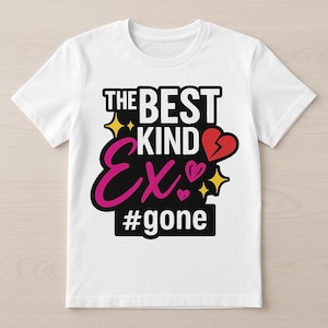 May include: White t-shirt with a graphic design. The design features the text "THE BEST KIND EX" in black and pink, with a broken heart and the hashtag "#gone". Gold starbursts and pink hearts accent the design.
