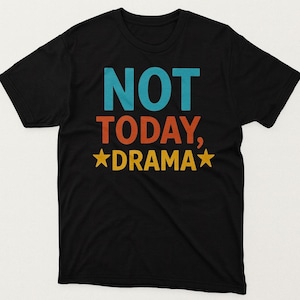 May include: Black t-shirt with the words "NOT TODAY, DRAMA" in teal, orange, and yellow. The text is centered on the front of the shirt. Two yellow stars flank the word "DRAMA".