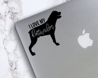 May include: Black and white silhouette of a Rottweiler dog with the text "I love my Rottweiler" on a silver laptop.