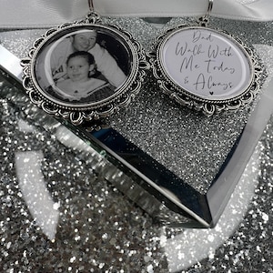 May include: Two silver charm ornaments. One features a black and white photo of a father and daughter. The other has the text "Dad Walk With Me Today & Always" with a small heart.