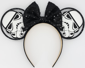 May include: Black and white Stormtrooper Mickey Mouse ears with a black sequined bow.
