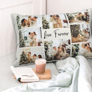 May include: A rectangular cushion with a white background and a collage of family photos. The photos are arranged in a grid pattern and feature a family of four, including a young child. The cushion has the text "Love Forever" printed in black cursive lettering.