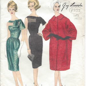 May include: A vintage sewing pattern for three dresses, designed by Guy Laroche. The pattern is for a green dress with a bow, a black dress with a scoop neck, and a red coat. The pattern number is 1492 and the design number is R253. The pattern is from the late 1950s.