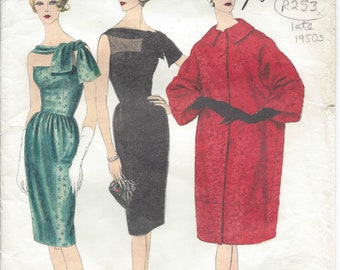 May include: A vintage sewing pattern for three dresses, designed by Guy Laroche. The pattern is for a green dress with a bow, a black dress with a scoop neck, and a red coat. The pattern number is 1492 and the design number is R253. The pattern is from the late 1950s.